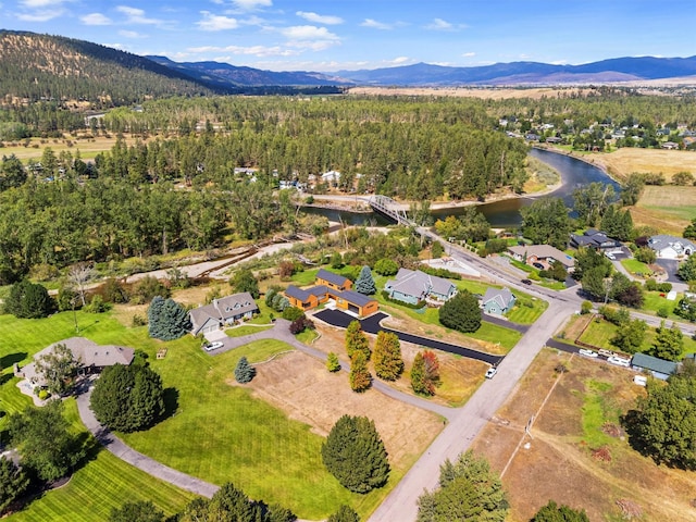 drone / aerial view featuring a water and mountain view