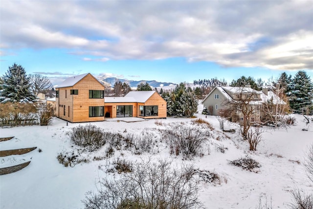 snow covered property with a mountain view