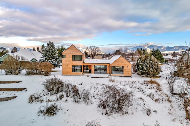 snow covered property with a mountain view