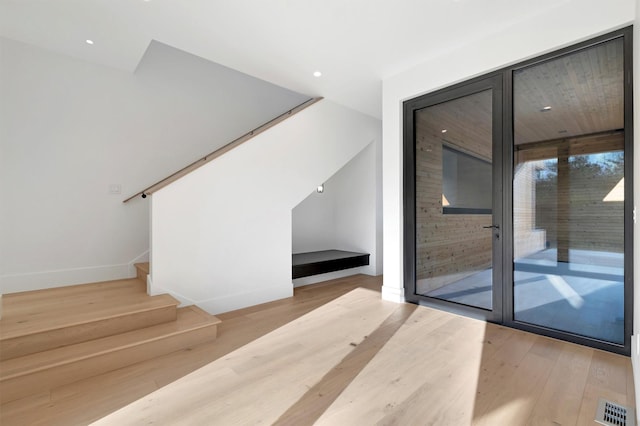 staircase with wood-type flooring