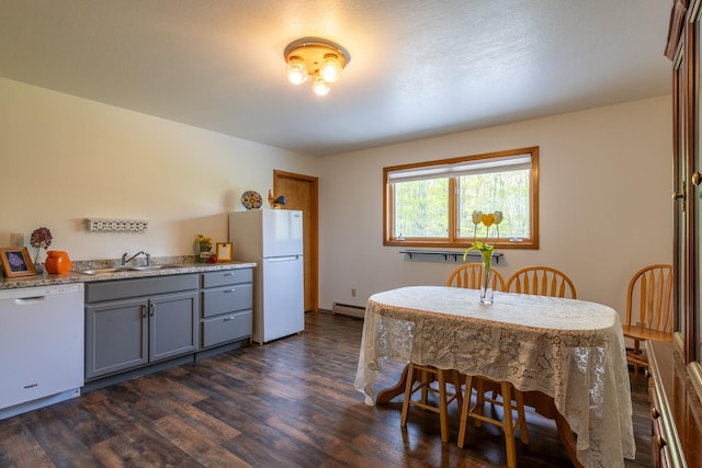 dining area featuring dark wood-type flooring and a baseboard radiator