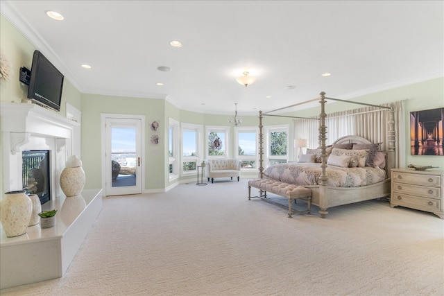 carpeted bedroom featuring ornamental molding, multiple windows, a premium fireplace, and access to outside