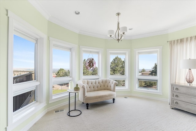 living area with ornamental molding, an inviting chandelier, and carpet