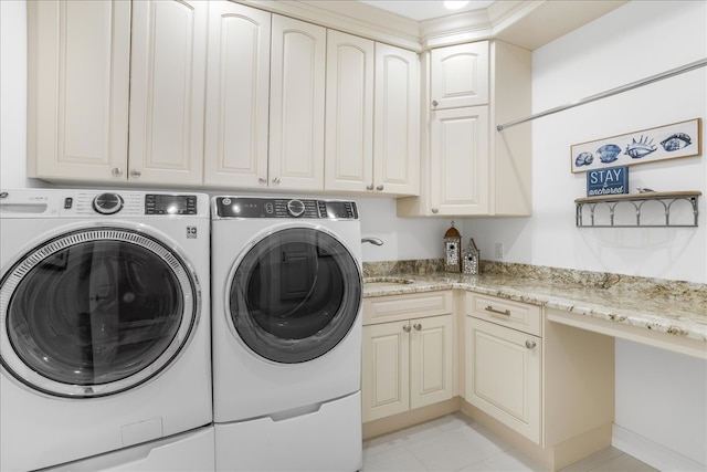 laundry room with cabinets, washing machine and dryer, sink, and light tile patterned flooring