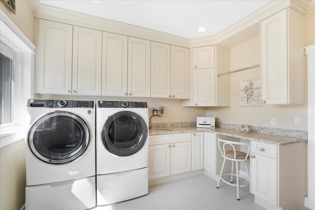 clothes washing area featuring cabinets, sink, independent washer and dryer, and light tile patterned flooring