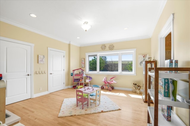 rec room featuring light hardwood / wood-style floors and ornamental molding