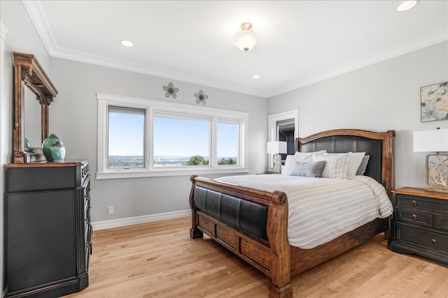 bedroom featuring light hardwood / wood-style floors and crown molding