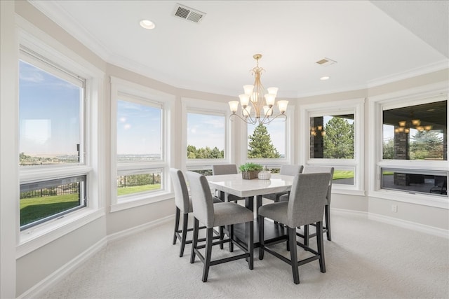 dining space with a notable chandelier, crown molding, light carpet, and a healthy amount of sunlight