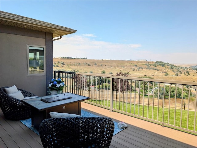 deck featuring a lawn and a rural view