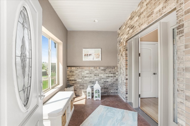 bathroom featuring hardwood / wood-style floors and brick wall