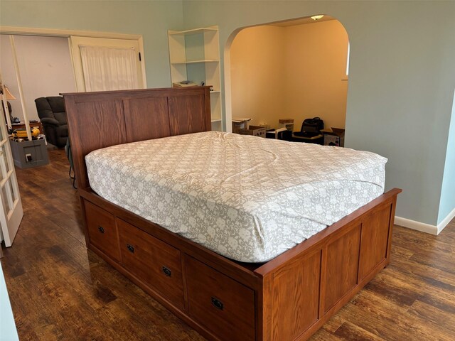 bedroom with dark wood-type flooring