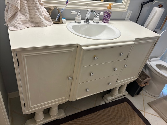 bathroom with vanity, toilet, and tile patterned floors