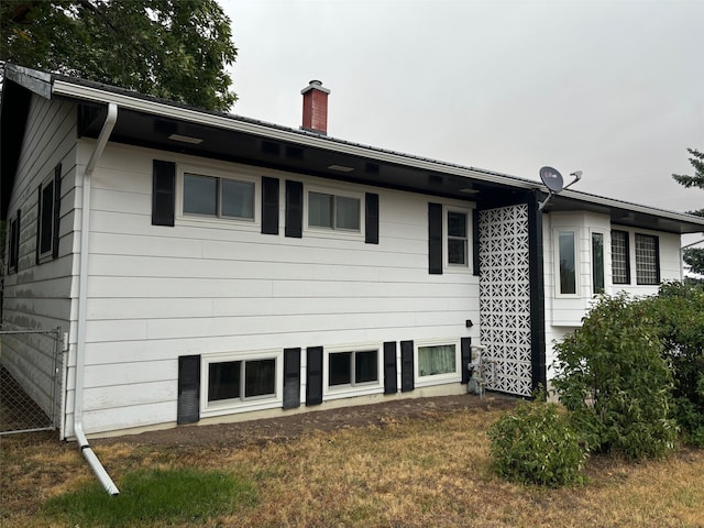 rear view of property with a yard