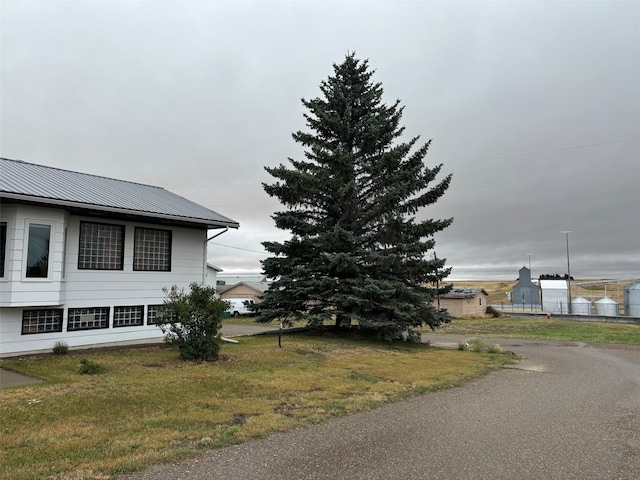 view of side of home with a lawn