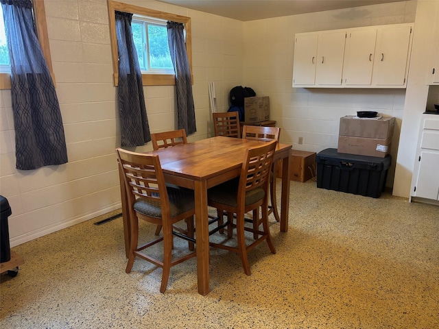 dining space with concrete block wall