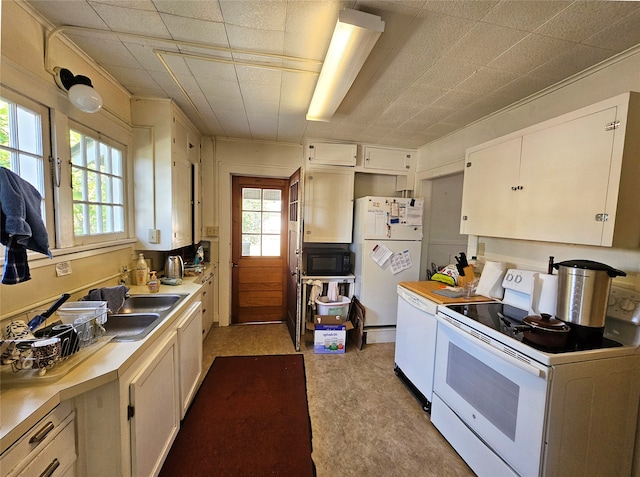 kitchen featuring white cabinets, white refrigerator, sink, and washer / clothes dryer