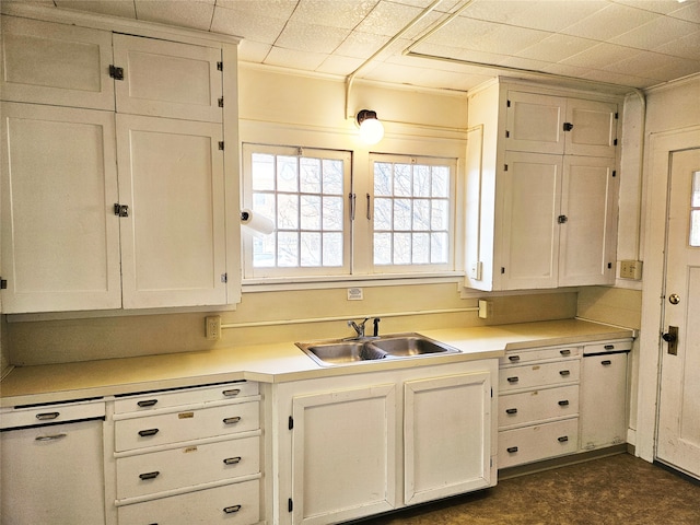 kitchen featuring white cabinetry, crown molding, and sink