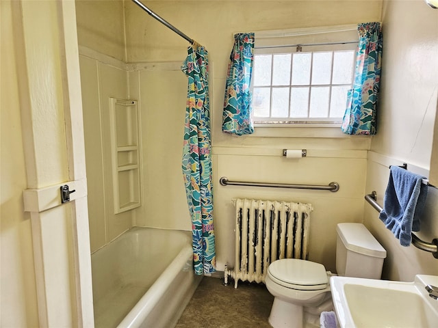 full bathroom featuring shower / bath combo with shower curtain, sink, radiator heating unit, and toilet