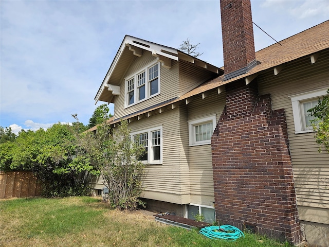 view of side of home featuring a lawn