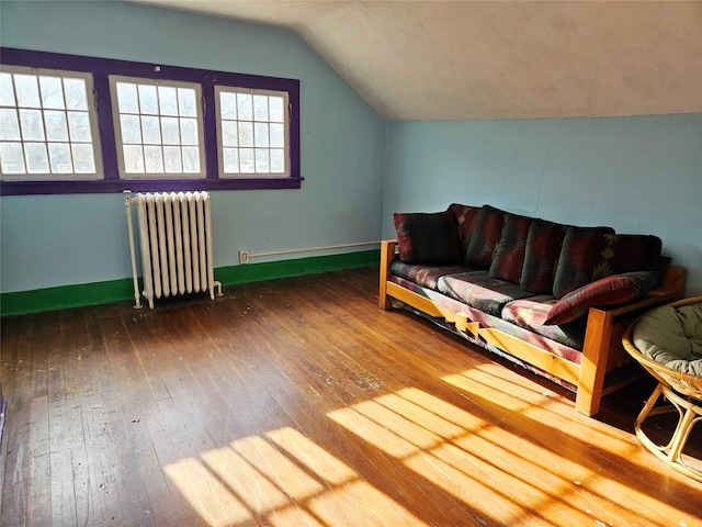 sitting room with lofted ceiling, wood-type flooring, and radiator