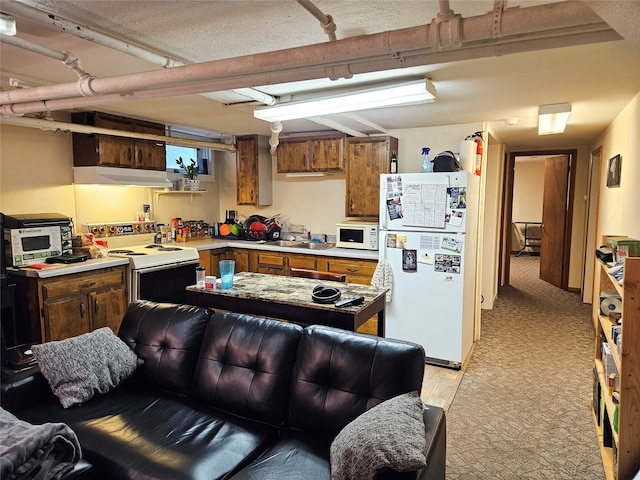 kitchen featuring a textured ceiling, white appliances, light colored carpet, and sink