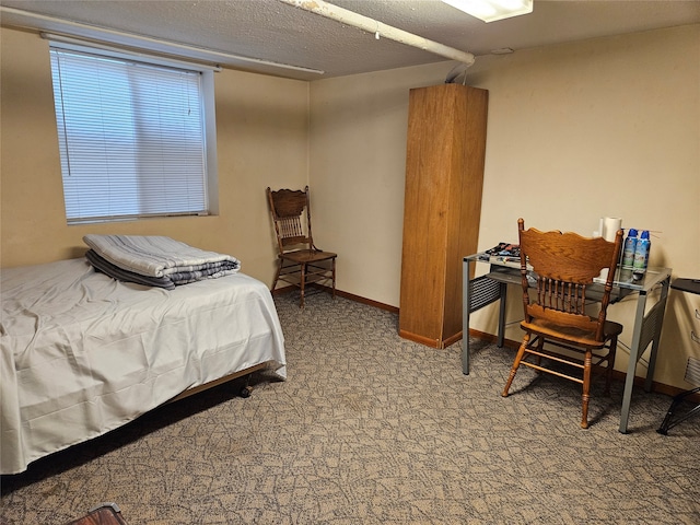 bedroom with carpet floors and a textured ceiling