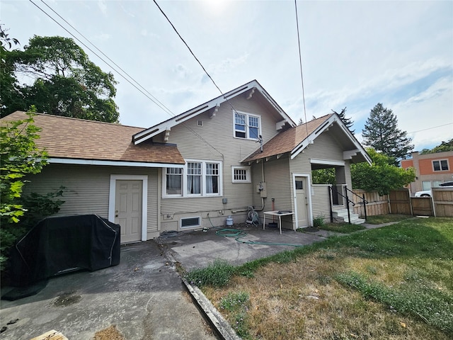 back of property featuring a lawn and a patio