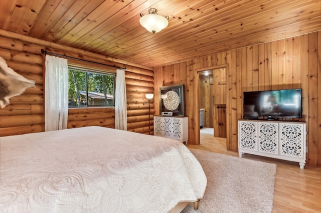 bedroom featuring light wood-type flooring, wood ceiling, and log walls