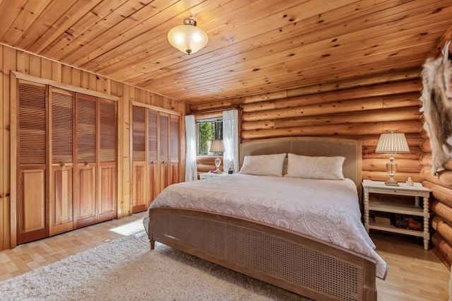 bedroom with multiple closets, light hardwood / wood-style flooring, log walls, and wooden ceiling