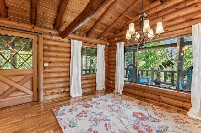 interior space featuring log walls, wooden ceiling, hardwood / wood-style floors, a notable chandelier, and vaulted ceiling with beams