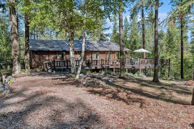 back of house featuring a deck