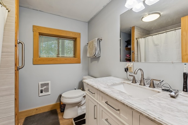 bathroom with vanity, toilet, wood-type flooring, and heating unit