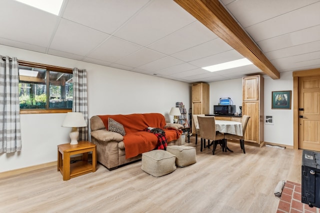 living room with beam ceiling and light hardwood / wood-style flooring