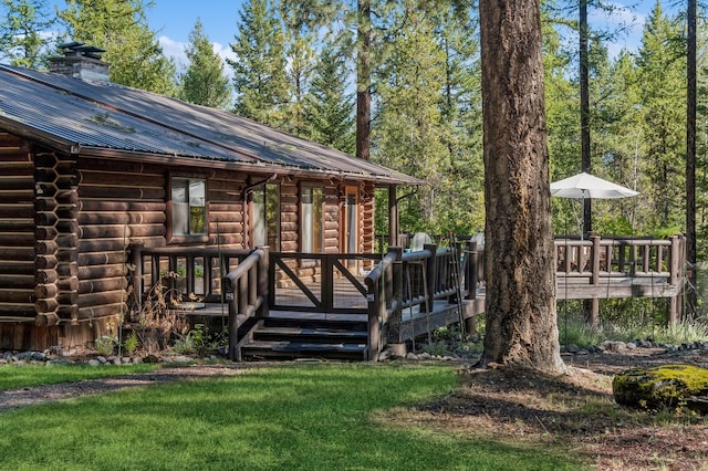 exterior space with a lawn and a wooden deck