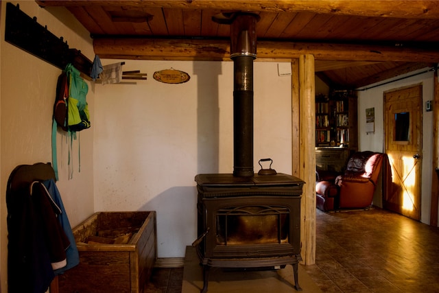 basement with wood ceiling and a wood stove