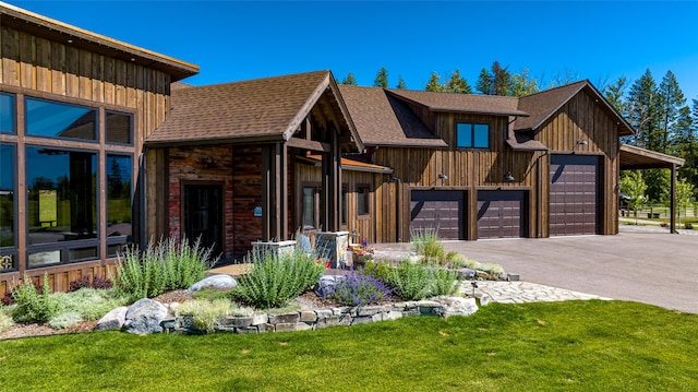 view of front of property with a garage and a front lawn