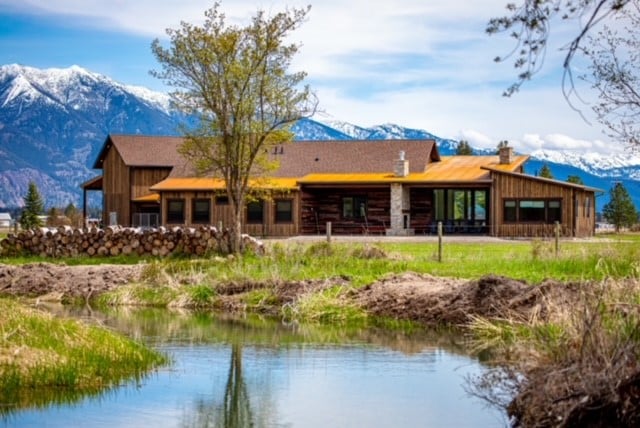 back of property featuring a water and mountain view