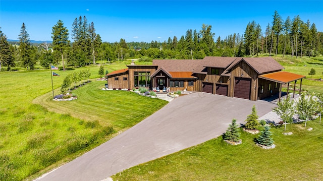 view of front of house with a garage and a front yard