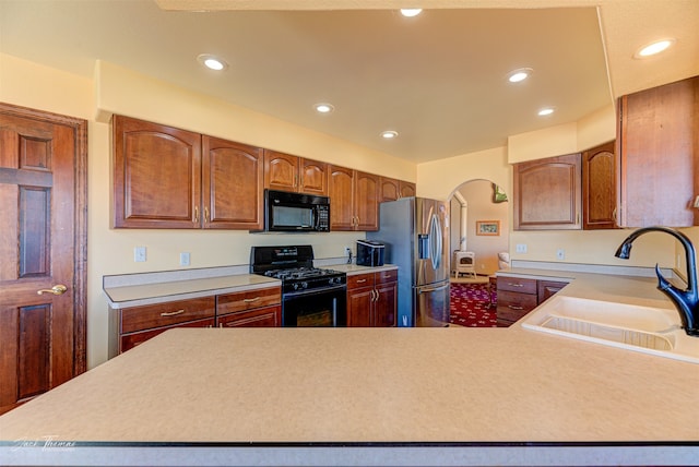 kitchen featuring black appliances and sink