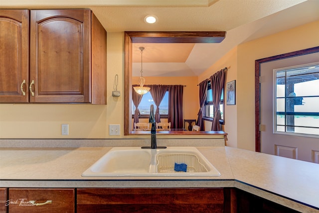 kitchen featuring a textured ceiling and sink