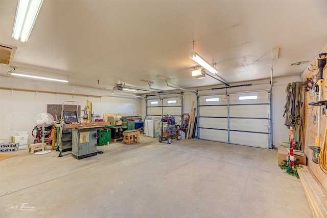 garage with a garage door opener and a workshop area