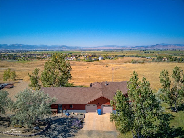 birds eye view of property featuring a mountain view and a rural view