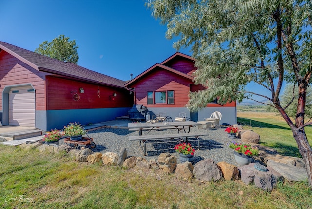 back of house with a yard and a patio