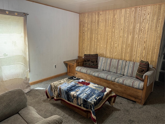 carpeted living room featuring wood walls