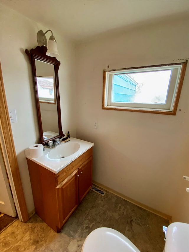 bathroom with vanity and toilet