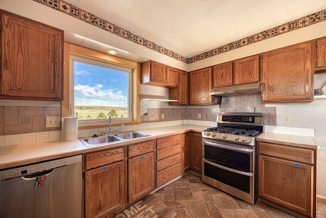 kitchen with decorative backsplash, stainless steel appliances, and sink