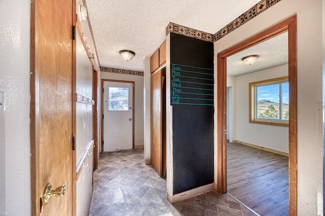 interior space featuring dark wood-type flooring and a textured ceiling