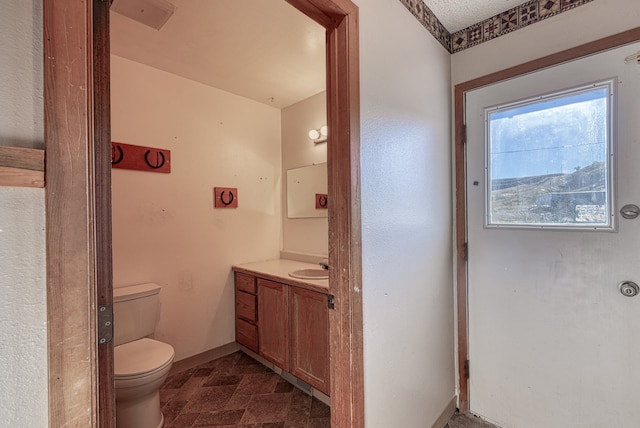 bathroom featuring toilet and vanity