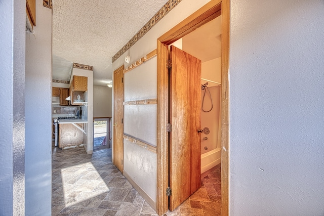 hallway featuring a textured ceiling