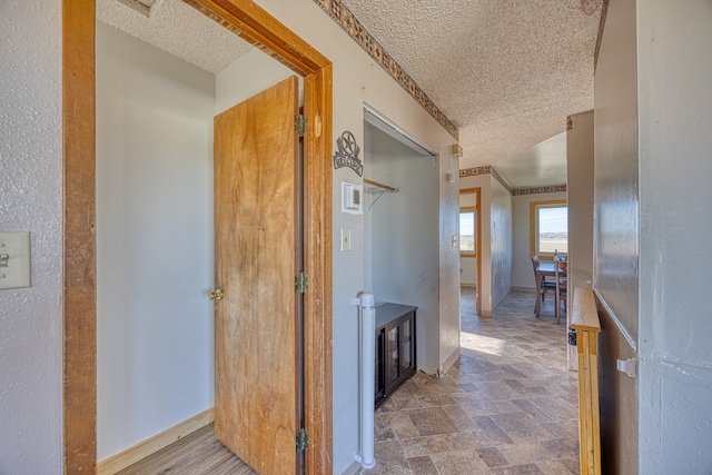 hall featuring a textured ceiling